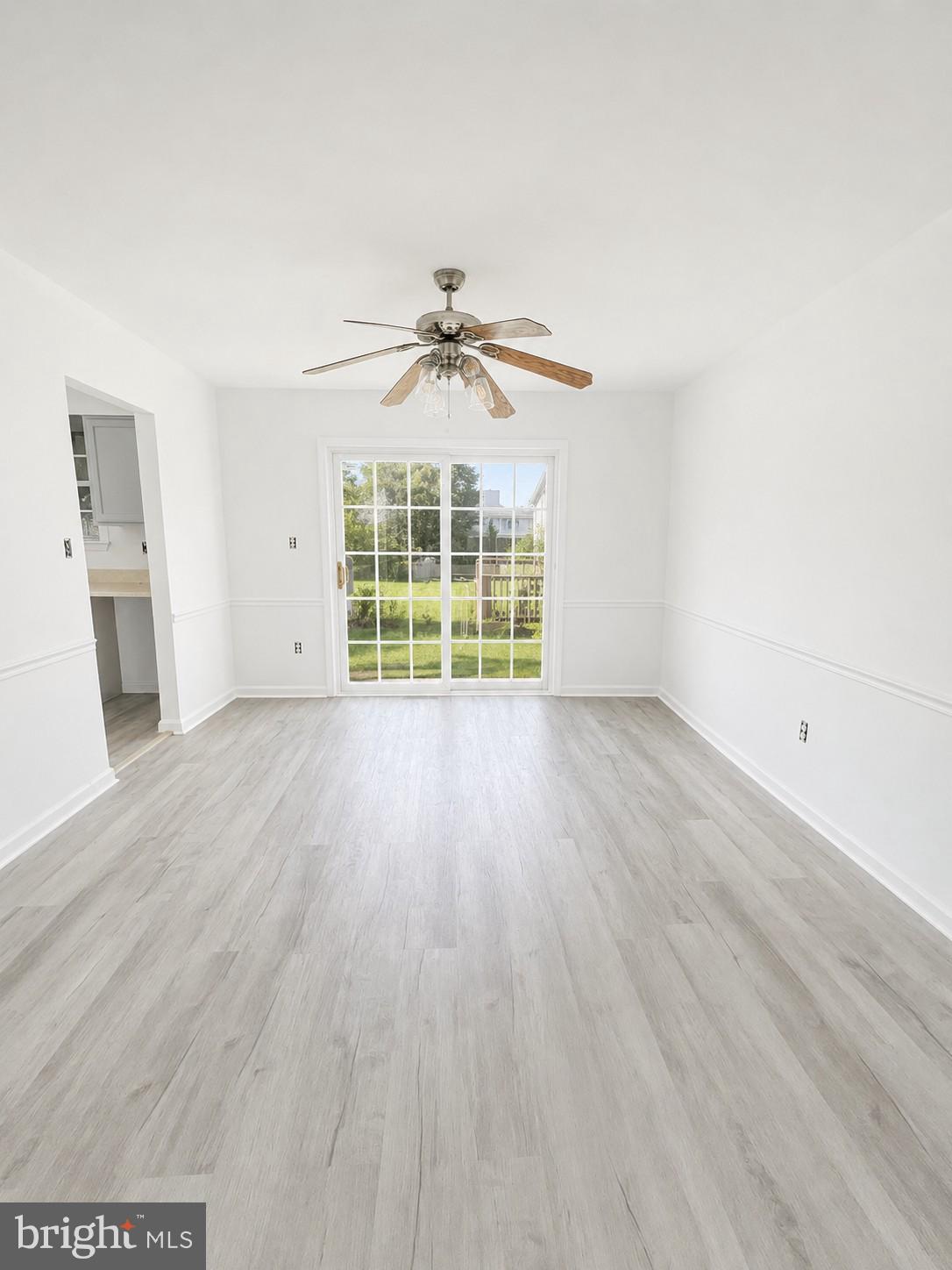 6204 Cipriano Road Lanham, MD 20706 - Photo 5 of 19 an empty room with wooden floor and windows