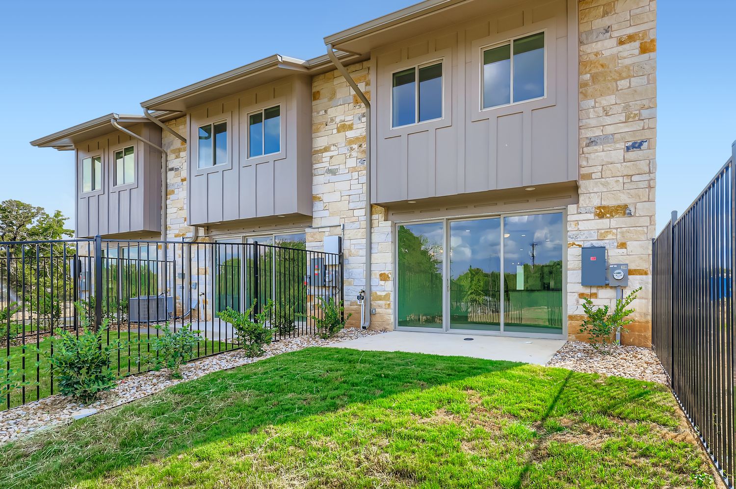 202 Tesla Circle Austin, TX 78681 - Photo 4 of 35 a view of a house with brick walls and a yard with plants