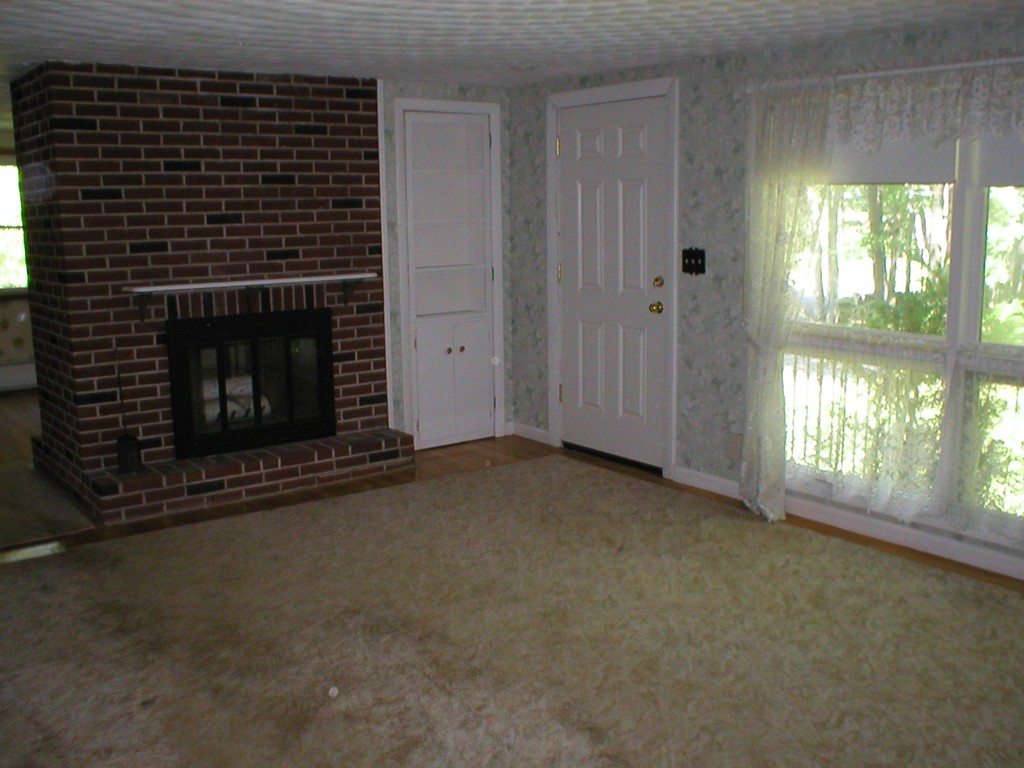 603 Turnpike Road Ashby, MA 01431 - Photo 7 of 17 a view of an empty room with a fireplace