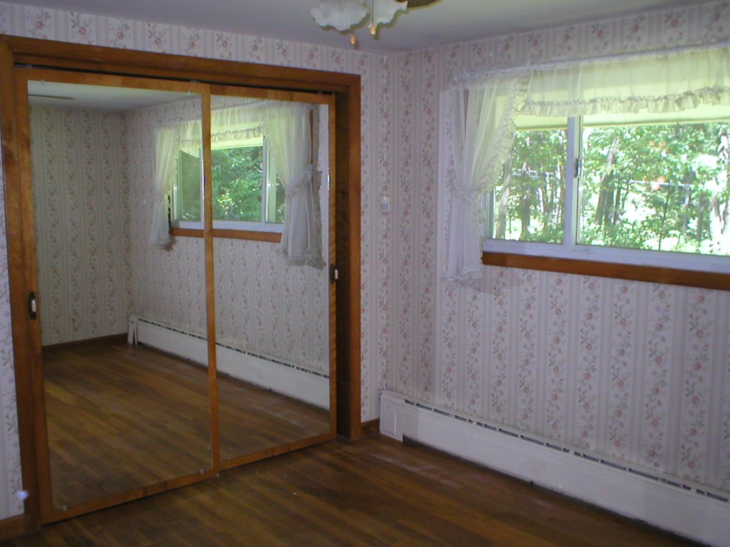 603 Turnpike Road Ashby, MA 01431 - Photo 9 of 17 an empty room with wooden floor and windows
