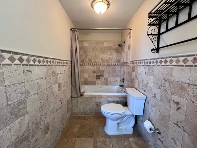 a bathroom with a toilet and a shower