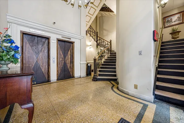 a view of a livingroom with wooden floor and stairs