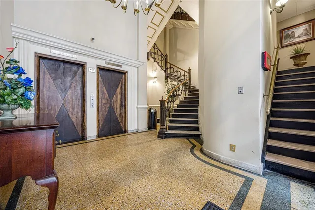a view of a livingroom with wooden floor and stairs