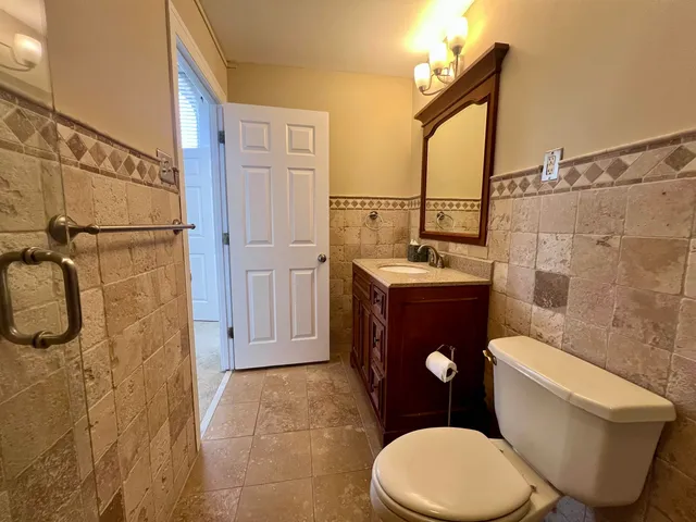 a white toilet sitting next to a bathroom sink