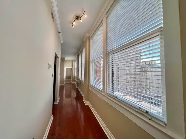 a view of a balcony with wooden floor