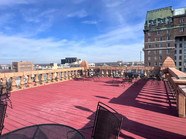 a swimming pool with outdoor seating and city view