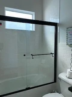 a bathroom with a shower and a toilet