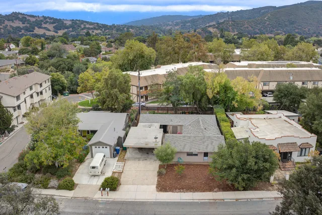 an aerial view of a house with a yard