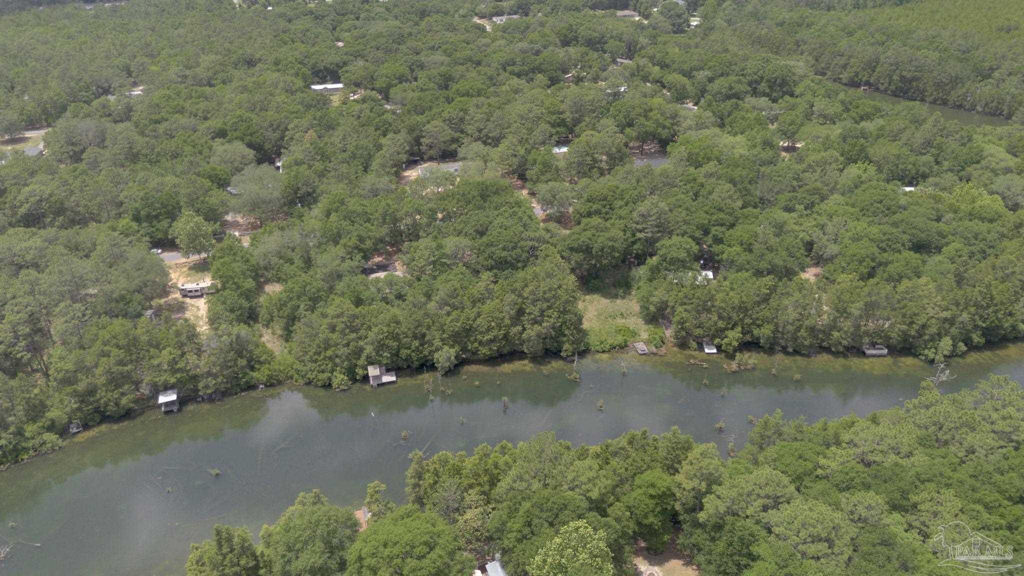 10290 West Lake Road Milton, FL 32583 - Photo 52 of 53 an aerial view of a houses with a yard and lake view
