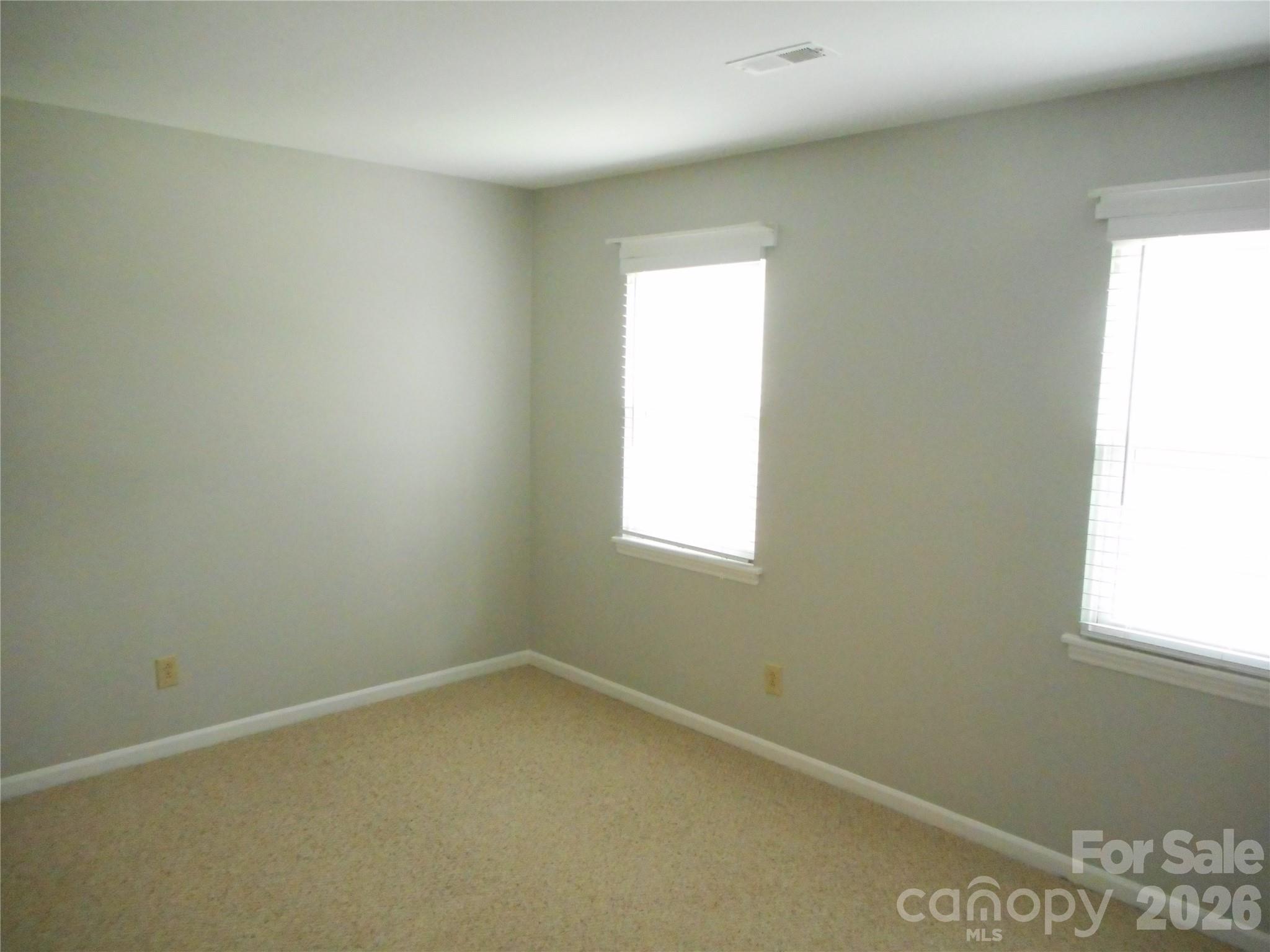 8001 Carmel Road Charlotte, NC 28226 - Photo 12 of 22 an empty room with a window