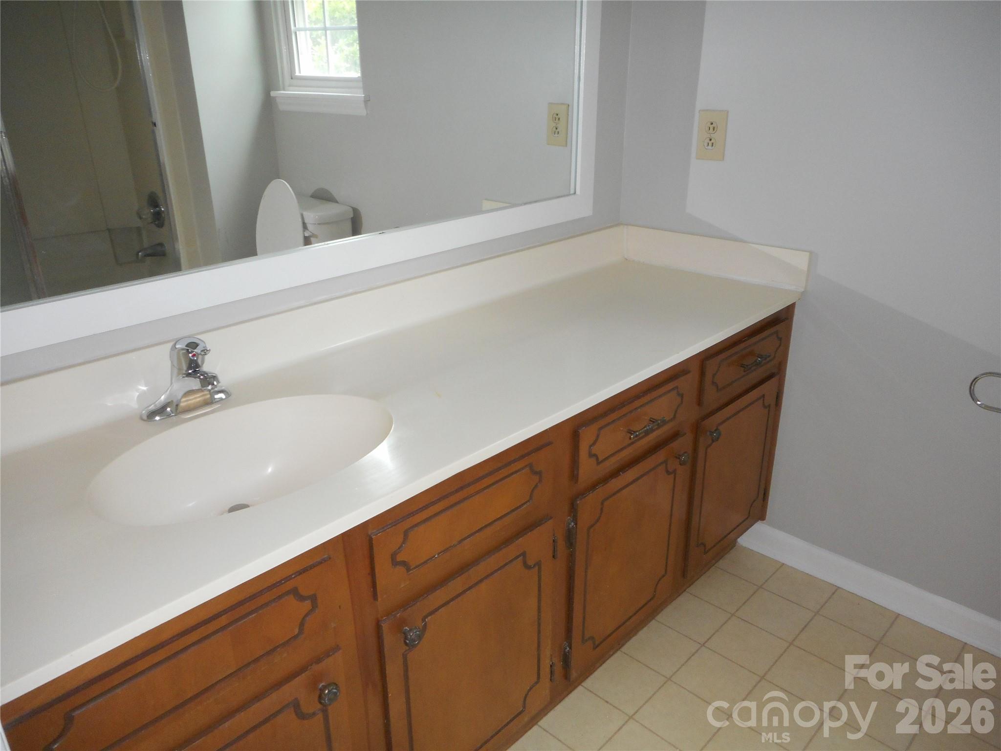 8001 Carmel Road Charlotte, NC 28226 - Photo 14 of 22 a bathroom with a sink and a mirror