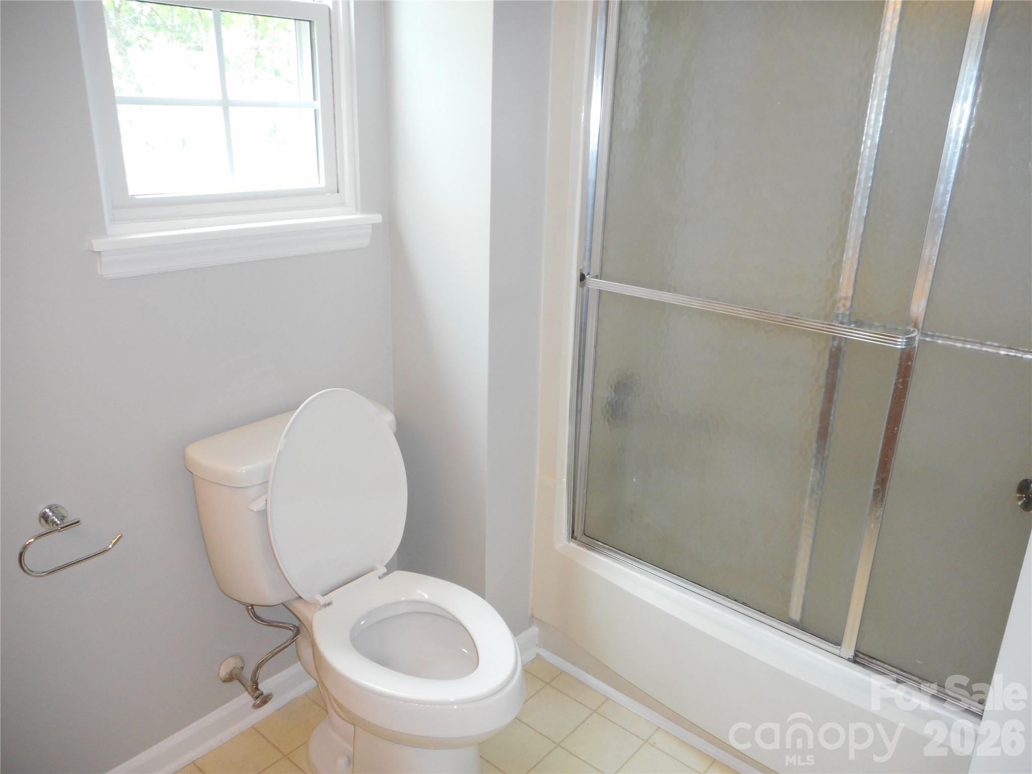 8001 Carmel Road Charlotte, NC 28226 - Photo 15 of 22 a white toilet sitting next to a window