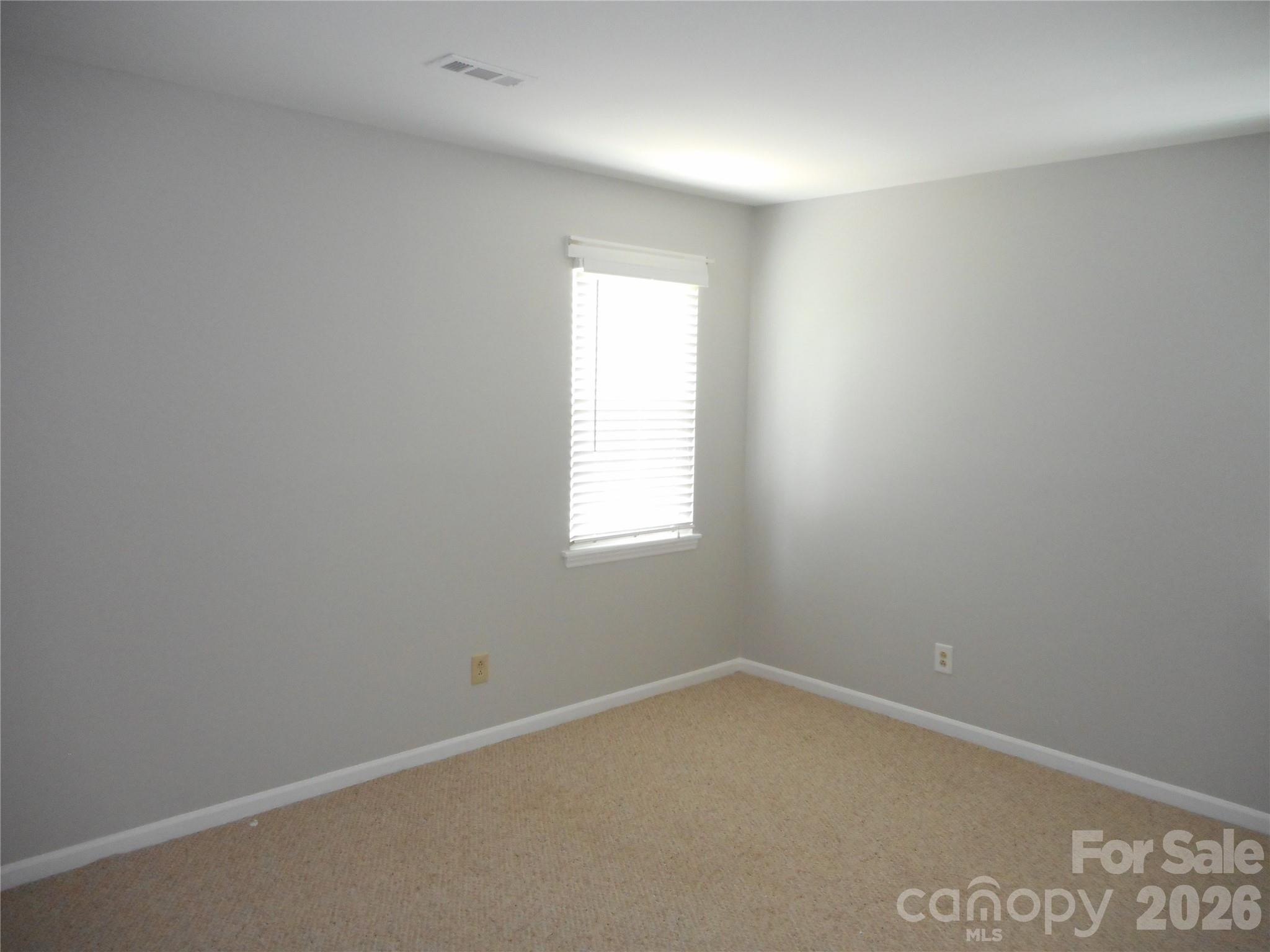 8001 Carmel Road Charlotte, NC 28226 - Photo 16 of 22 an empty room with a window