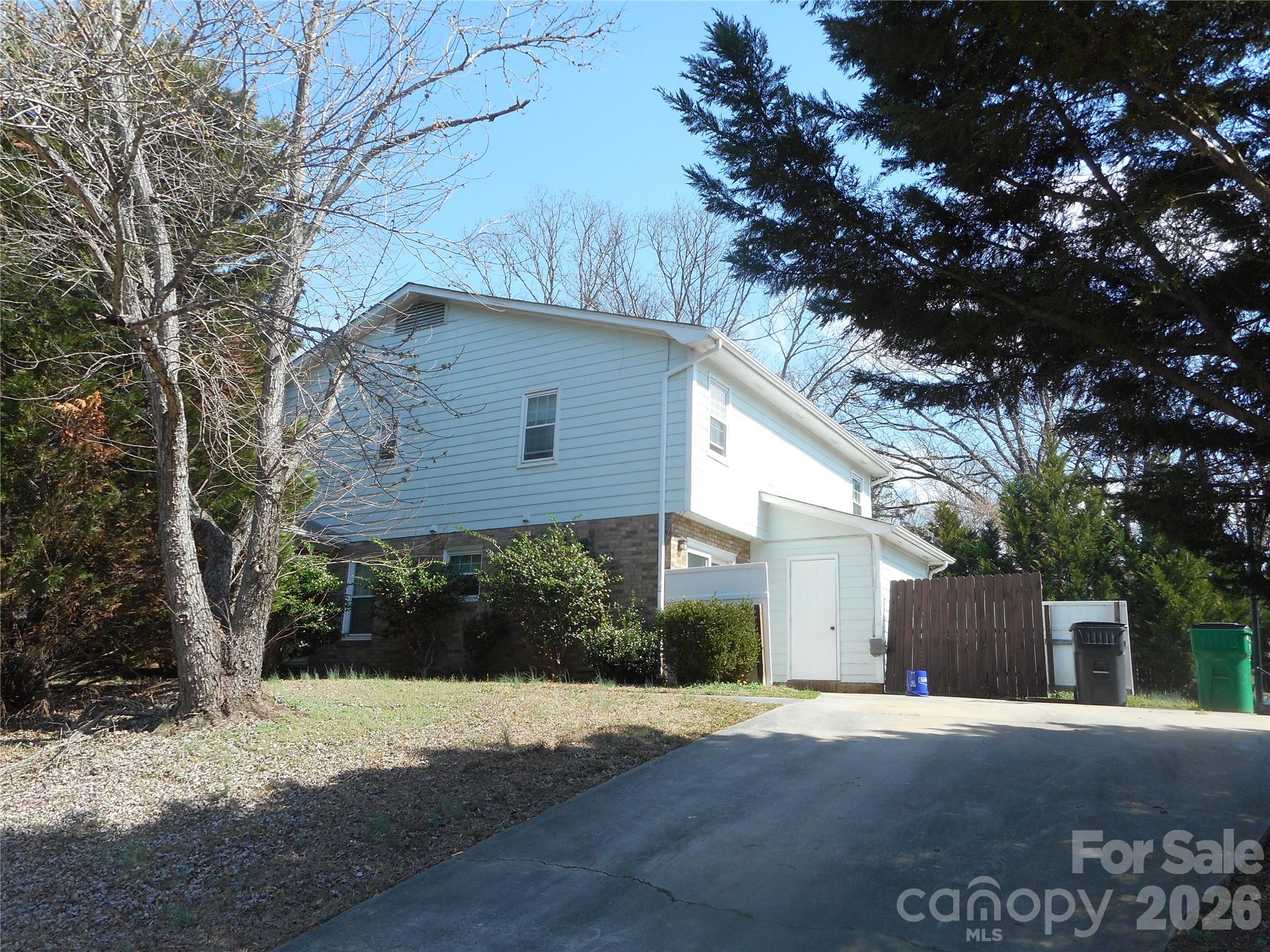 8001 Carmel Road Charlotte, NC 28226 - Photo 18 of 22 a front view of a house with a yard