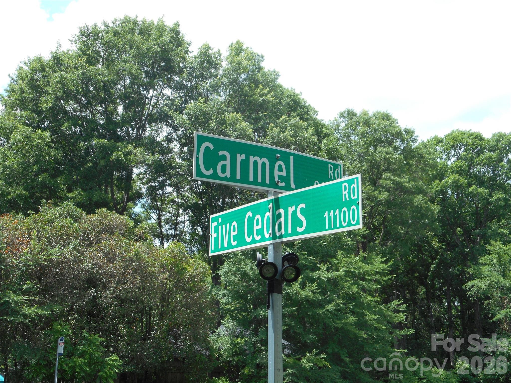 8001 Carmel Road Charlotte, NC 28226 - Photo 2 of 22 a street sign sitting on a pole on a road