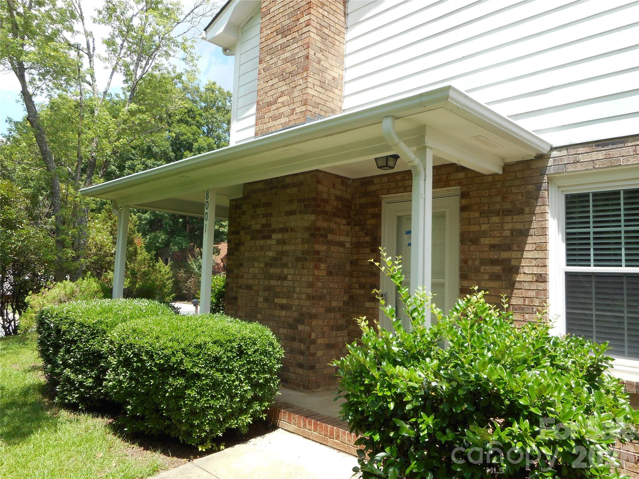 8001 Carmel Road Charlotte, NC 28226 - Photo 3 of 22 a front view of a house with garden