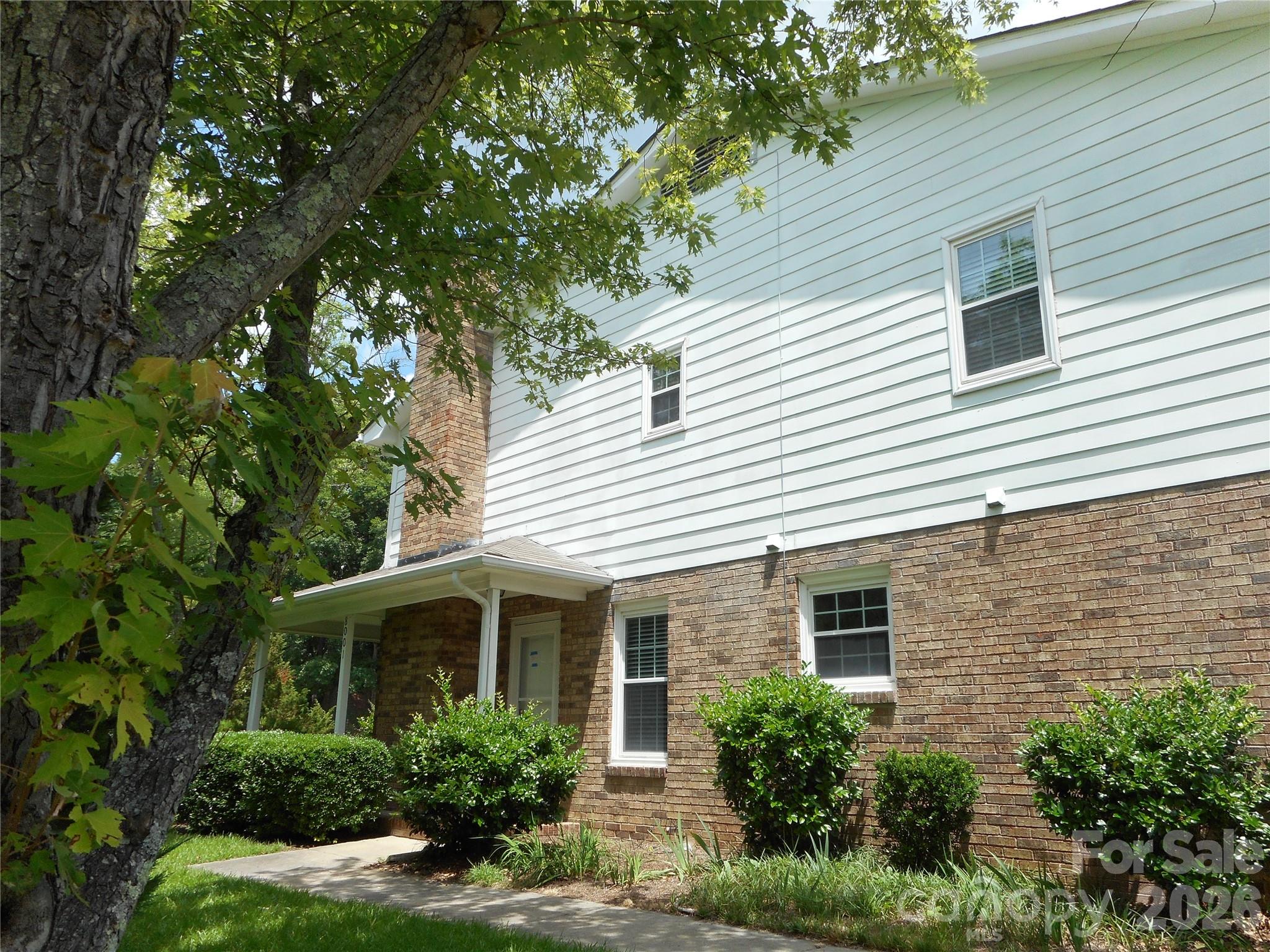 8001 Carmel Road Charlotte, NC 28226 - Photo 5 of 22 a front view of a house with garden