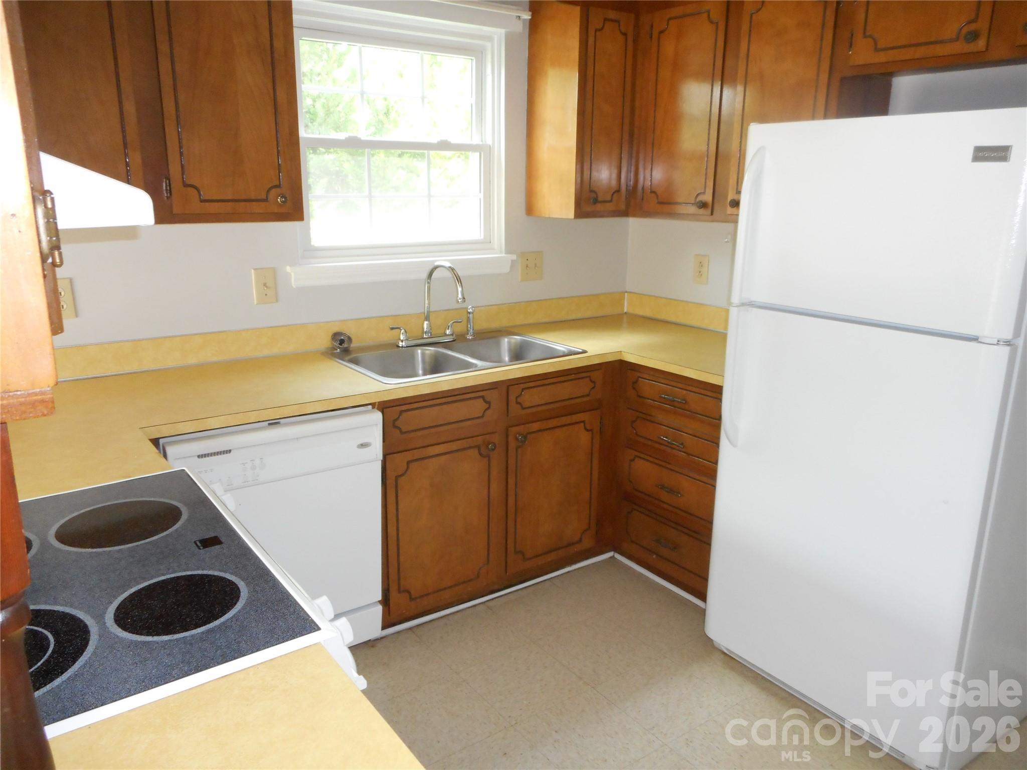 8001 Carmel Road Charlotte, NC 28226 - Photo 9 of 22 a kitchen with a refrigerator and a sink