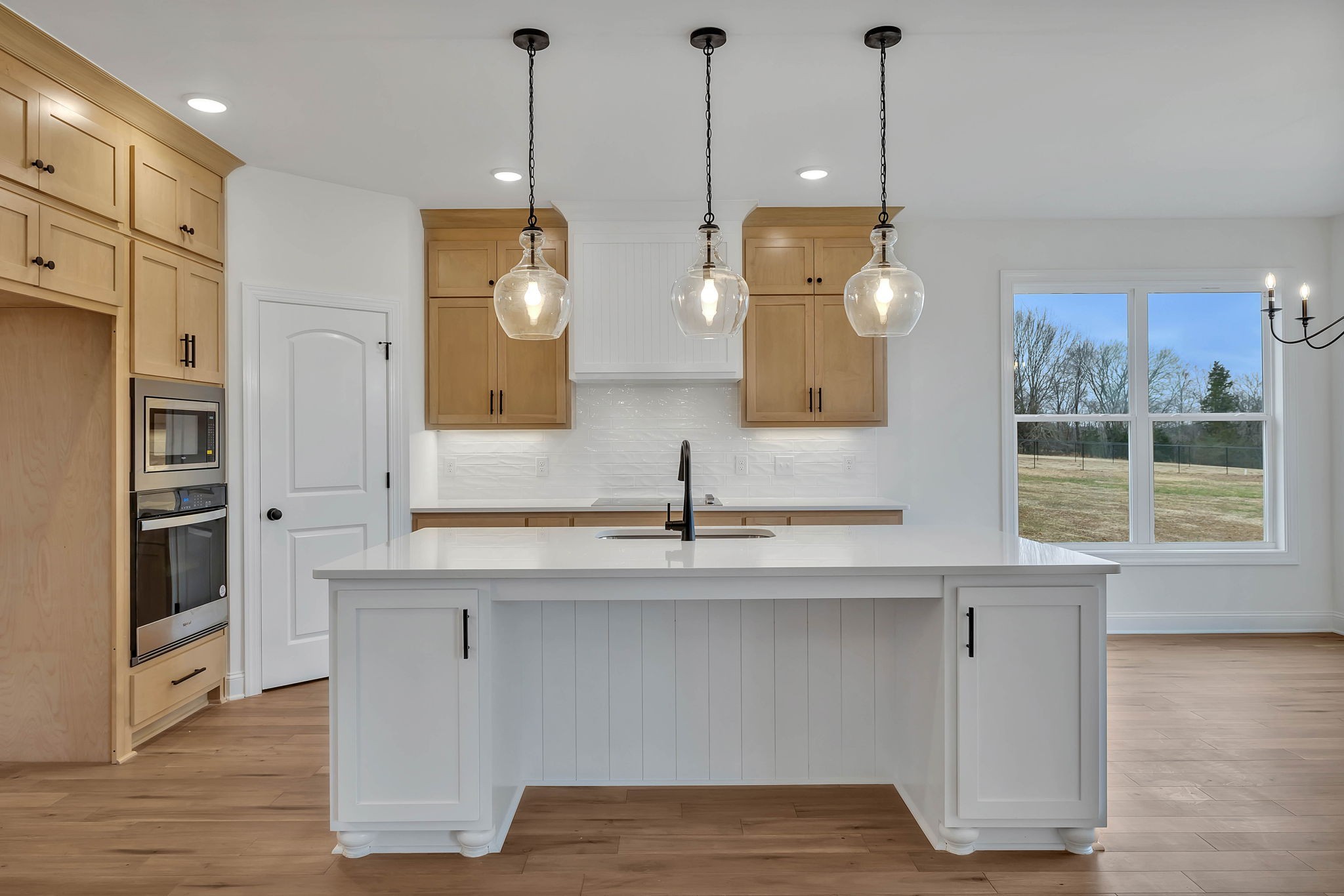 7341 North Milton Road Milton, TN 37118 - Photo 11 of 36 a view of a kitchen counter space with wooden floor and windows