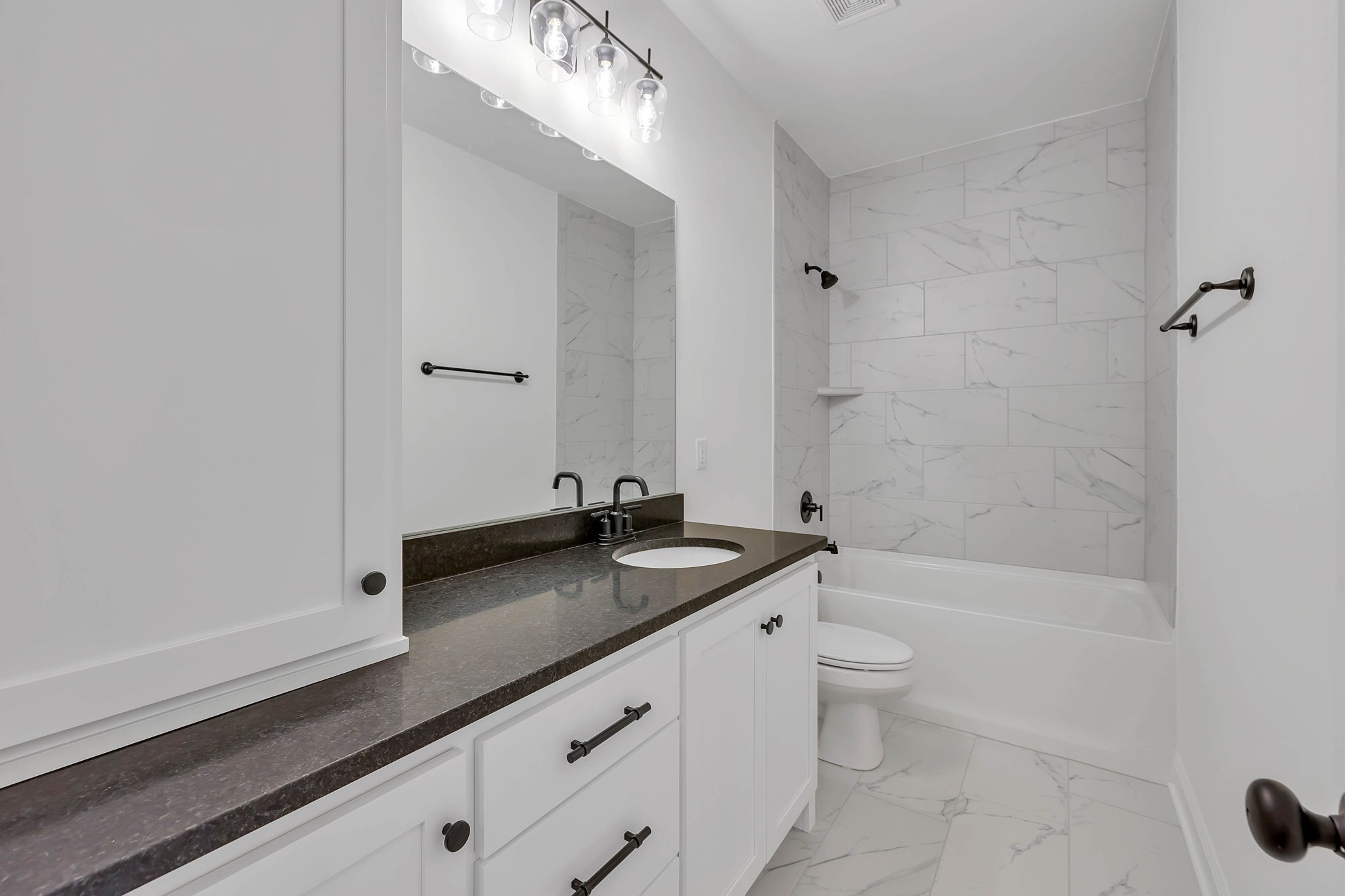 7341 North Milton Road Milton, TN 37118 - Photo 27 of 36 a bathroom with a granite countertop sink a toilet a mirror and bathtub