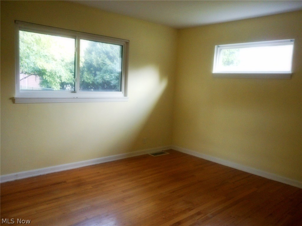 908 Jacoby Road Akron, OH 44321 - Photo 12 of 24 Bedroom with neutral paint , updated windows, and hardwood floors.