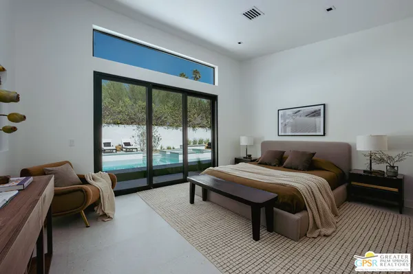 a bedroom with a bed and a large window