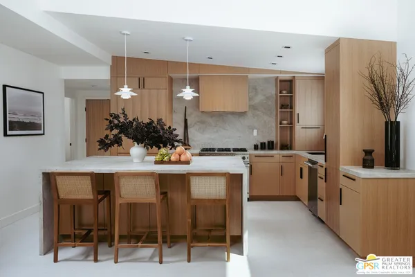 a kitchen with cabinets and chairs