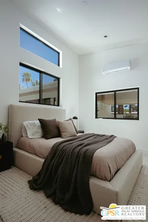 a bedroom with a bed and balcony