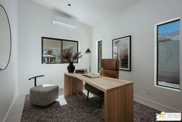 a workspace with furniture and mirror