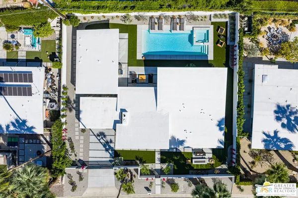an aerial view of a house with a yard