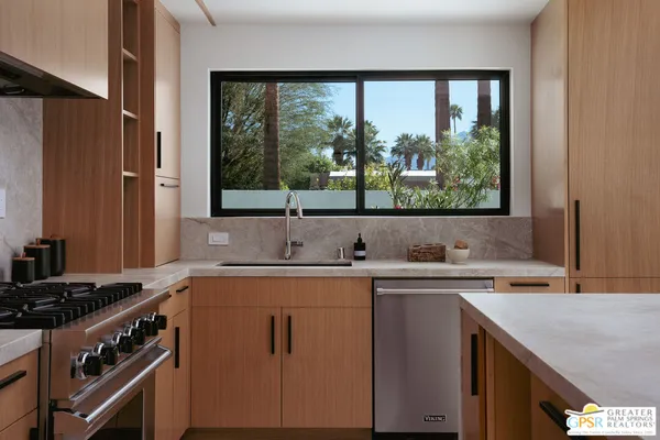 a kitchen with a sink stove and cabinets