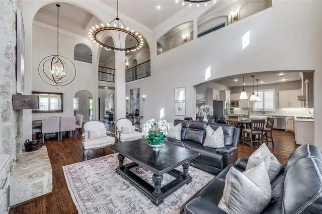 a living room with lots of furniture and view of kitchen
