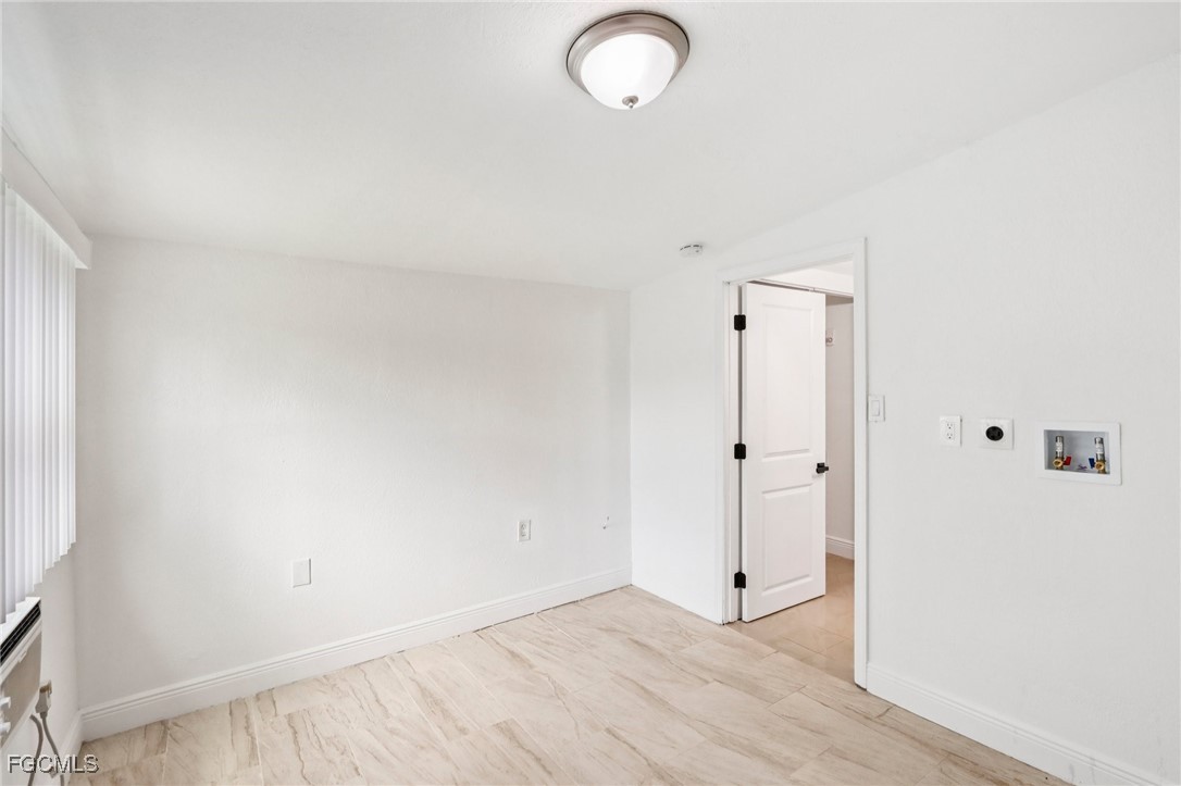 89 Cabana Avenue North Fort Myers, FL 33903 - Photo 13 of 29 a view of a room with wooden floor and mirror