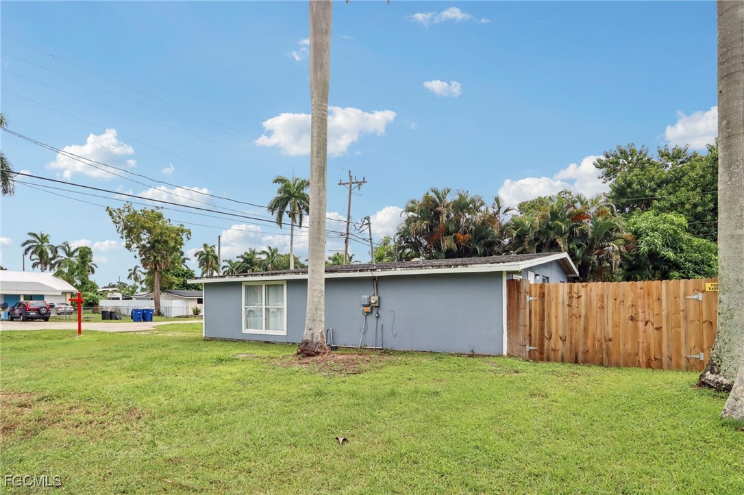 89 Cabana Avenue North Fort Myers, FL 33903 - Photo 21 of 29 a backyard of a house with table and chairs a barbeque with wooden fence