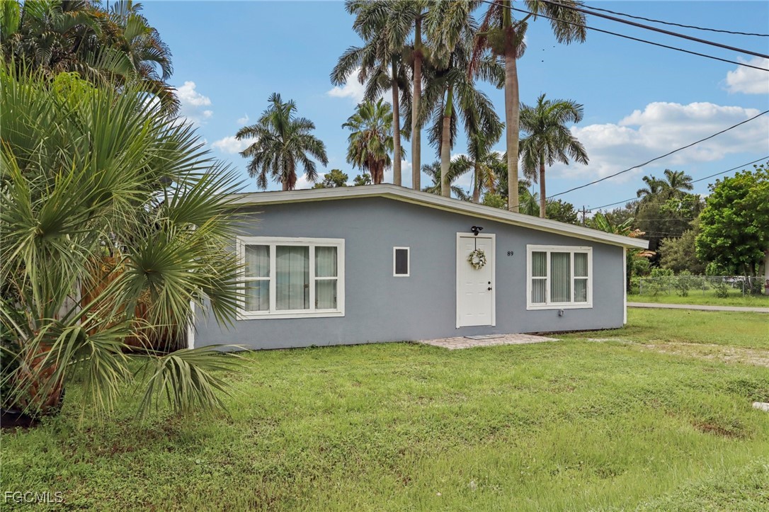 89 Cabana Avenue North Fort Myers, FL 33903 - Photo 26 of 29 a house with palm tree in front of it