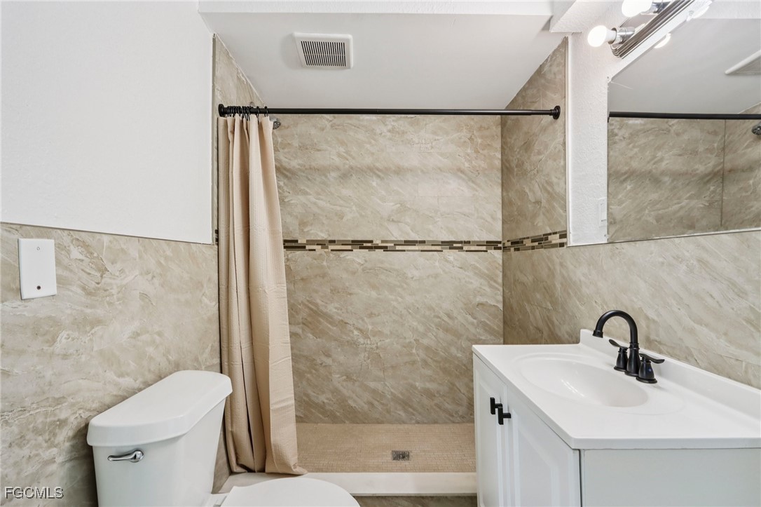 89 Cabana Avenue North Fort Myers, FL 33903 - Photo 5 of 29 a bathroom with a sink mirror toilet and shower