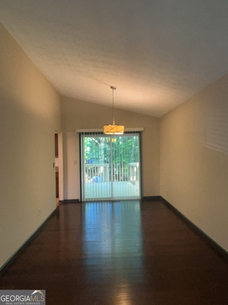 1265 Herrington Road Lawrenceville, GA 30044 - Photo 9 of 52 a view of an empty room with wooden floor and a window