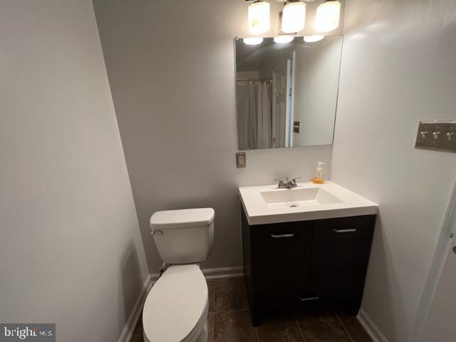 908 Chatsworth Drive Accokeek, MD 20607 - Photo 19 of 24 a bathroom with a toilet sink and mirror