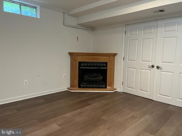 908 Chatsworth Drive Accokeek, MD 20607 - Photo 2 of 24 a view of an empty room with wooden floor and a fireplace