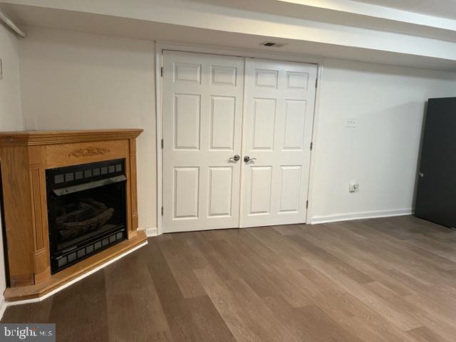 908 Chatsworth Drive Accokeek, MD 20607 - Photo 3 of 24 a view of an empty room with wooden floor fireplace and a window
