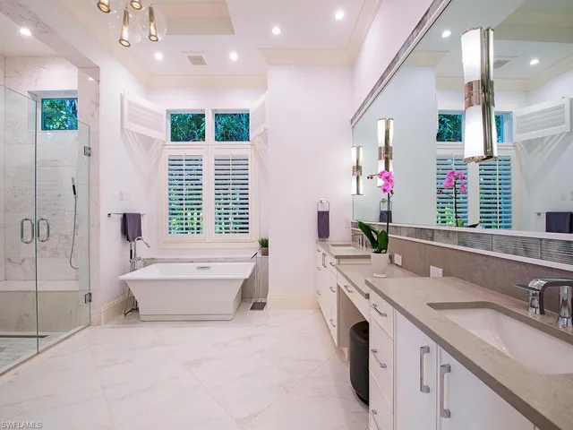 a spacious bathroom with a granite countertop tub sink and mirror