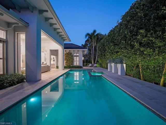 a view of an house with swimming pool yard and outdoor seating