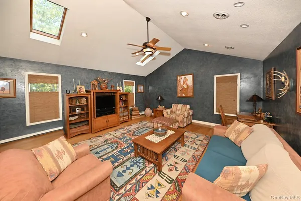 a living room with furniture and a ceiling fan