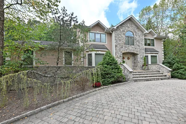 a front view of a house with a garden