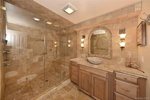a spacious bedroom with a bed and a chandelier