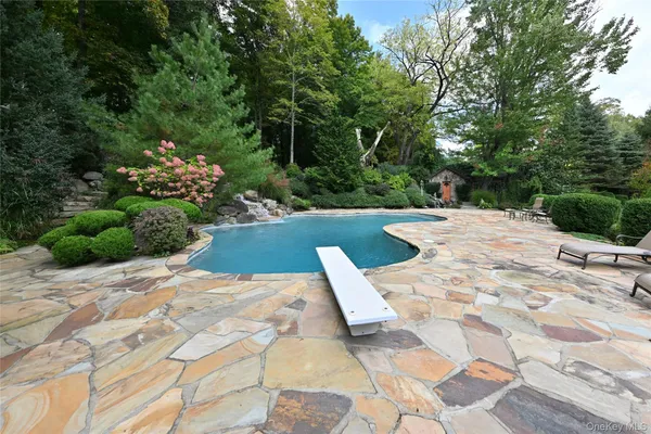 a view of a house with swimming pool and sitting area