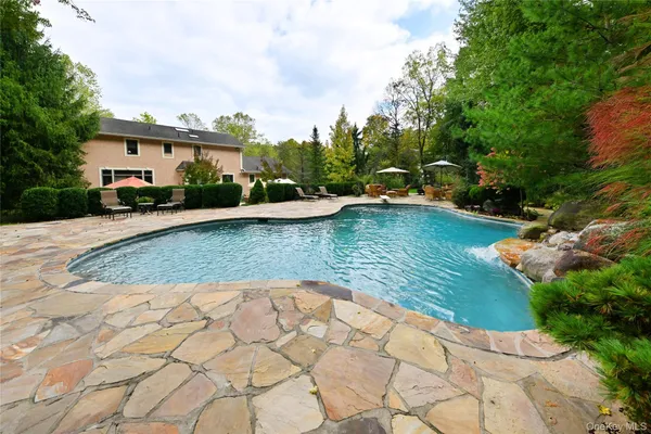 a backyard of a house with outdoor seating