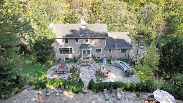 an aerial view of a house with yard swimming pool and outdoor seating