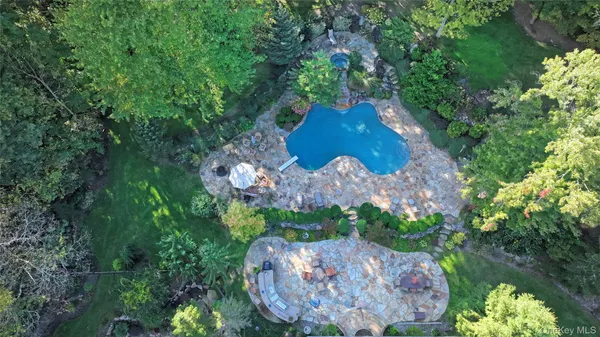 an aerial view of a house with a yard and green space