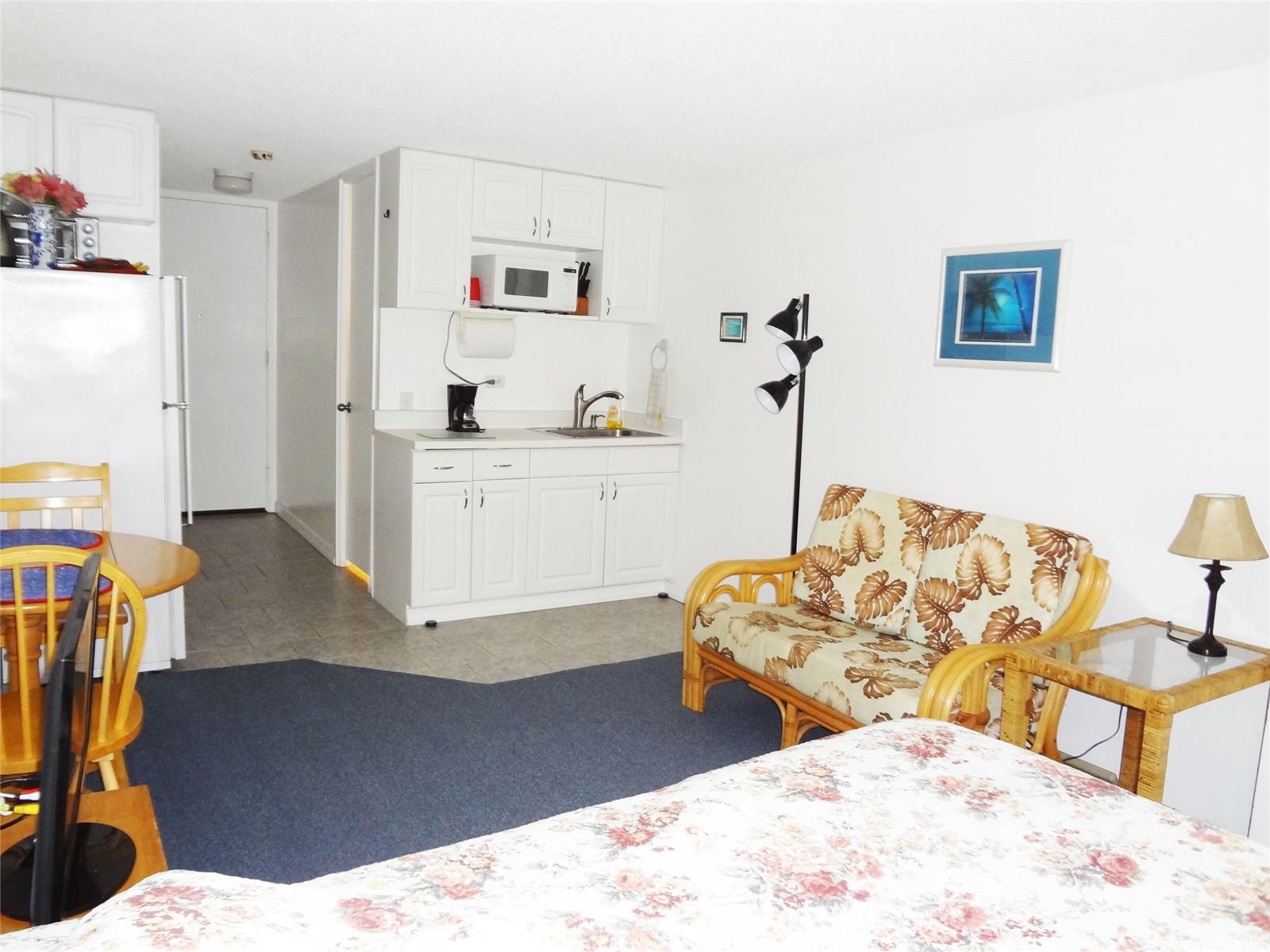 2572 Lemon Road, Unit 502 Honolulu, HI 96815 - Photo 2 of 7 a living room with furniture and wooden floor